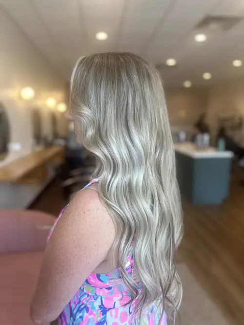 Long champagne blonde waves with a natural root melt by an Ash and Ivy Salon colorist in Evans, GA